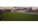 A single story home features lush landscaping, a large lawn, and a spacious three-car garage at 8515 Belcastro St, Las Vegas, NV 89113