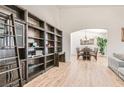 Bright living room with high ceilings, custom built-in bookshelves, and wood-look flooring at 8515 Belcastro St, Las Vegas, NV 89113