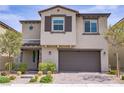 Two story home exterior with a two car garage, desert landscaping and brick paver walkway at 8564 Scalpay St, Las Vegas, NV 89166