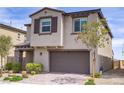 Charming two-story home with stucco facade, stone accents, a two-car garage, and professionally landscaped front yard at 8564 Scalpay St, Las Vegas, NV 89166