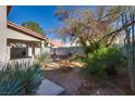 Spacious backyard with minimal landscaping, covered patio, offering potential for customization and outdoor enjoyment at 8771 Martinique Bay Ln, Las Vegas, NV 89147