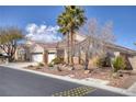 Charming single-story home featuring a three-car garage, desert landscaping, and tile roof at 8894 Don Horton Ave, Las Vegas, NV 89178