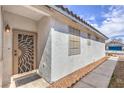 Close up of front entrance and artistic security door, with low maintenance landscaping at 9193 Black Slate St, Las Vegas, NV 89123