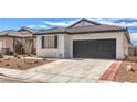 Charming single story home with a gray garage door and low maintenance desert landscaping at 9193 Black Slate St, Las Vegas, NV 89123