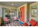 Charming patio with seating, a view to the living area through sliding doors, and a stylish front door at 1541 Unison Way # 102, Las Vegas, NV 89135