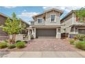 Charming two-story home features a paved brick driveway, two-car garage, and manicured front yard at 160 Lilt Ave, Henderson, NV 89011