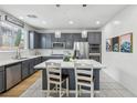 Modern kitchen featuring white countertops, a large kitchen island, stainless appliances, and pendant lighting at 160 Lilt Ave, Henderson, NV 89011