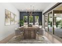 Elegant dining room with modern chandelier and views of the outdoor space, virtually staged for inspiration at 177 Cactus Sunrise St, Las Vegas, NV 89138