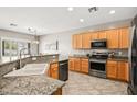 Bright kitchen with granite countertops and stainless steel appliances at 2104 Willow Wren Dr, North Las Vegas, NV 89084