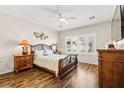Cozy bedroom with wood floors, ceiling fan, and natural light at 2104 Willow Wren Dr, North Las Vegas, NV 89084