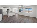 Bright living room featuring an open concept and vinyl floors, complemented by natural light from large windows at 2606 Lily Point St, Las Vegas, NV 89156