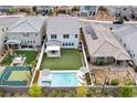 Aerial view of backyard, with pool, sports court, patio, manicured lawns, and outdoor furniture at 2616 Tolmezzo St, Henderson, NV 89044