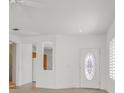 Welcoming living room with a decorative front door and view into kitchen at 3036 Monroe Park Rd, Henderson, NV 89052