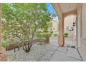 Quaint front porch area with desert landscaping and stone ground cover with an open entry way at 3457 Abilene Gold Ct, Las Vegas, NV 89129