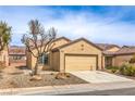 Charming single-story home featuring desert landscaping, a two-car garage, and a neutral color scheme at 3520 Kittiwake Rd, North Las Vegas, NV 89084