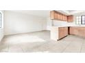 Open-concept living space with tile floors, neutral walls, and a light wood breakfast bar with kitchen access at 4131 Gannet Cir # 389, Las Vegas, NV 89103