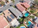 Aerial view of a neighborhood, showing several homes with pools and well manicured lawns at 4921 Lazy Day Ct, Las Vegas, NV 89131