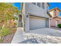 Two-story home featuring a gray painted facade, attached two car garage, and front door with short staircase at 4921 Lazy Day Ct, Las Vegas, NV 89131