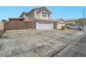 Inviting two-story home showcasing a wide driveway, two car garage, and decorative gate for added privacy at 5364 Awbury Ave, Las Vegas, NV 89110