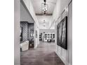 Bright foyer with high ceilings, wood floors, statement lighting, with seamless access to other living spaces at 5715 Golden Chase Ct, Las Vegas, NV 89131