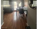 Cozy dining area featuring wood floors, seating for four, and sliding glass doors at 7098 Forest Vista St, Las Vegas, NV 89147