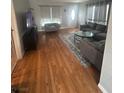 Living room featuring hardwood floors, modern decor, and comfortable seating at 7098 Forest Vista St, Las Vegas, NV 89147