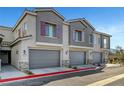 Townhome exteriors with gray garages, colorful shutters, and manicured landscaping on a sunny day at 7204 N Decatur Blvd, North Las Vegas, NV 89131