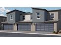 Modern townhome garages offer convenience and secure parking in a stylish exterior at 7405 Harmon Falls Ct # 1093/226, North Las Vegas, NV 89084