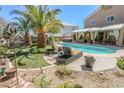 Relaxing backyard featuring a pool, lounge chairs, and manicured landscaping at 8120 Neptune Beach Ave, Las Vegas, NV 89128