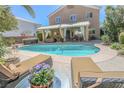 Inviting backyard pool with ample space for relaxing and entertaining with shaded patio at 8120 Neptune Beach Ave, Las Vegas, NV 89128