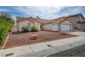Inviting single-story home with xeriscaped front yard, three-car garage at 8301 Shad Bush Ave, Las Vegas, NV 89149