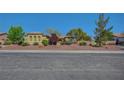 Attractive desert-landscaped home featuring mature trees and a well-maintained lawn in a lovely neighborhood at 8370 Unicorn St, Las Vegas, NV 89131