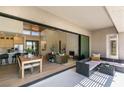 Open living area with a view to the backyard, an outdoor sitting area and access to a covered patio at 9425 Villa Ridge Dr, Las Vegas, NV 89134