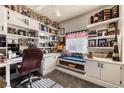 Well-lit office space featuring custom built-ins, desk, carpet, and comfortable seating, perfect for remote work and organization at 9692 Waukegan Ave, Las Vegas, NV 89148