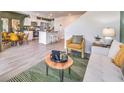 Open-concept living and kitchen area with modern flooring, stylish furniture, and an abundance of natural light at , North Las Vegas, NV 89084
