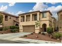 Inviting two-story home featuring a two-car garage and a charming front yard with landscaped details at 10766 La Florentina Ave, Las Vegas, NV 89166