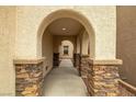 Inviting covered walkway with stone pillars leads to the home's entrance at 10766 La Florentina Ave, Las Vegas, NV 89166