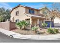 Charming stucco home with a welcoming front porch, desert landscaping, and a convenient two-car garage at 1307 Summer Dawn Ave, Henderson, NV 89014