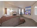 Comfortable living room with fireplace, entertainment center, and natural light at 1636 Royal Palm Dr, Las Vegas, NV 89128