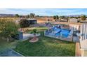 Backyard oasis with a sparkling pool and lush green lawn at 2125 Mateuse St, Logandale, NV 89021