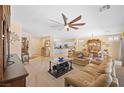 Comfortable living room with ceiling fan and seamless flow to kitchen and dining at 2320 Anderson Park Dr, Henderson, NV 89044