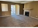 Carpeted living room with a fireplace and a sliding glass door to a balcony at 2750 S Durango Dr # 2027, Las Vegas, NV 89117