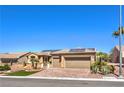 Welcoming single-story home features lush landscaping, brick driveway, and two-car garage at 2776 White Sage Dr, Henderson, NV 89052
