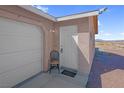 Close up view of the home's entrance next to the garage and desert landscaping at 2831 Goldrush St, Pahrump, NV 89048