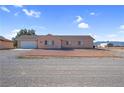 Charming single-story home featuring a two-car garage and low maintenance desert landscaping at 2831 Goldrush St, Pahrump, NV 89048