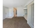 Open-concept living space with tile entryway, plush carpeting, and bright neutral paint at 3523 Mercury St # A, North Las Vegas, NV 89030