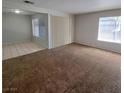 Inviting living room featuring a mix of carpet and tile flooring, and plenty of natural light at 3523 Mercury St # A, North Las Vegas, NV 89030