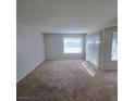 Large living room with plush carpeting, bright window with blinds, and plenty of natural light at 3523 Mercury St # G, North Las Vegas, NV 89030