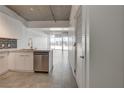 Bright modern kitchen with stainless steel dishwasher, sleek cabinets, and tiled floors at 353 E Bonneville Ave # 904, Las Vegas, NV 89101