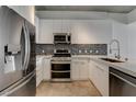 Modern kitchen featuring stainless steel appliances, white cabinets, and a stylish backsplash at 353 E Bonneville Ave # 904, Las Vegas, NV 89101